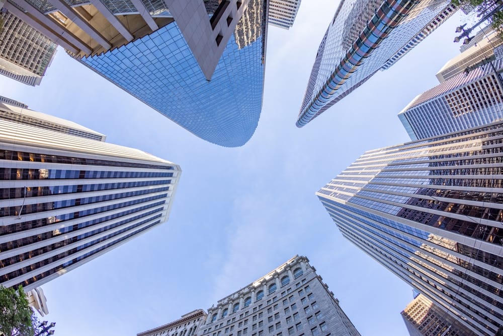 Skyline of modern office towers in a downtown business district, symbolizing corporate real estate and parking opportunities.